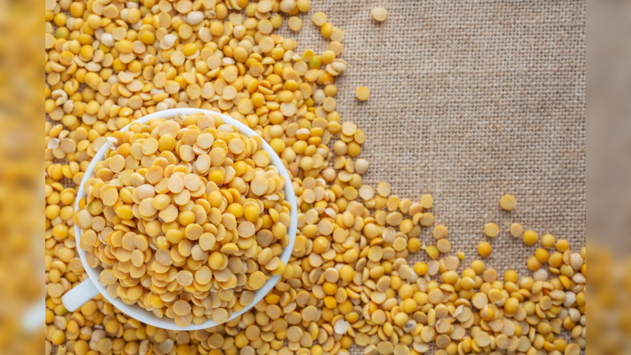 3. Moong Dal (24g protein per 100g)- Yellow moong dal in wooden bowl.